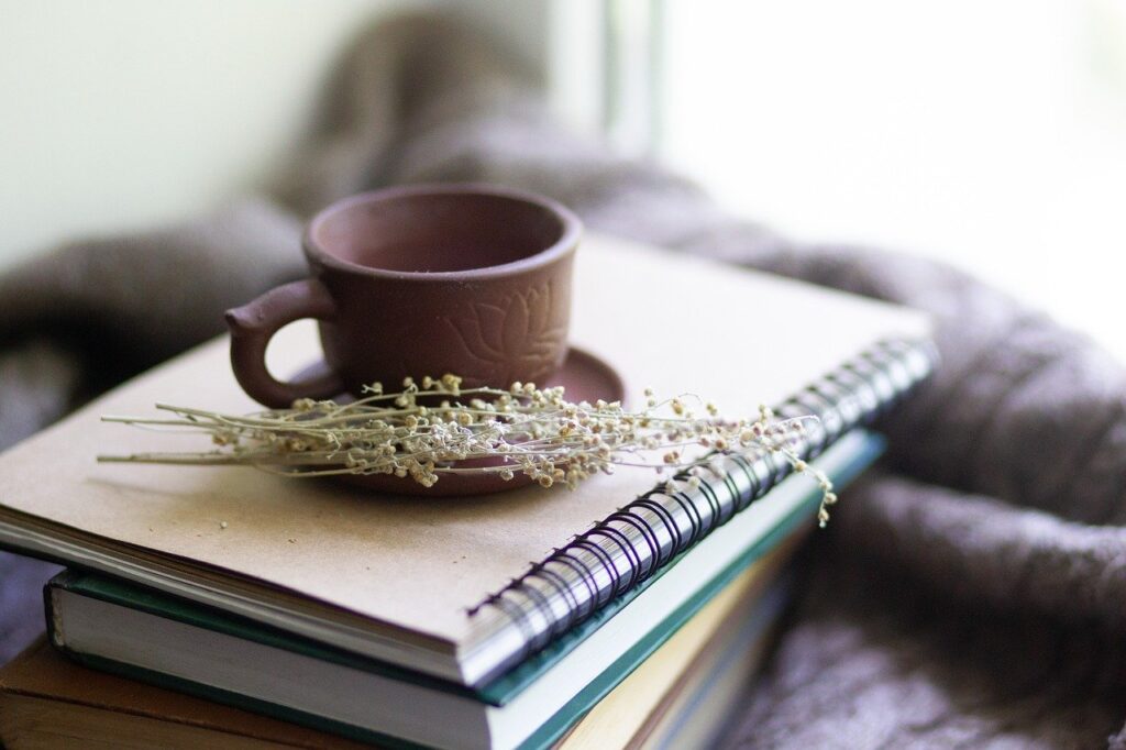 Books, cup and flowers.