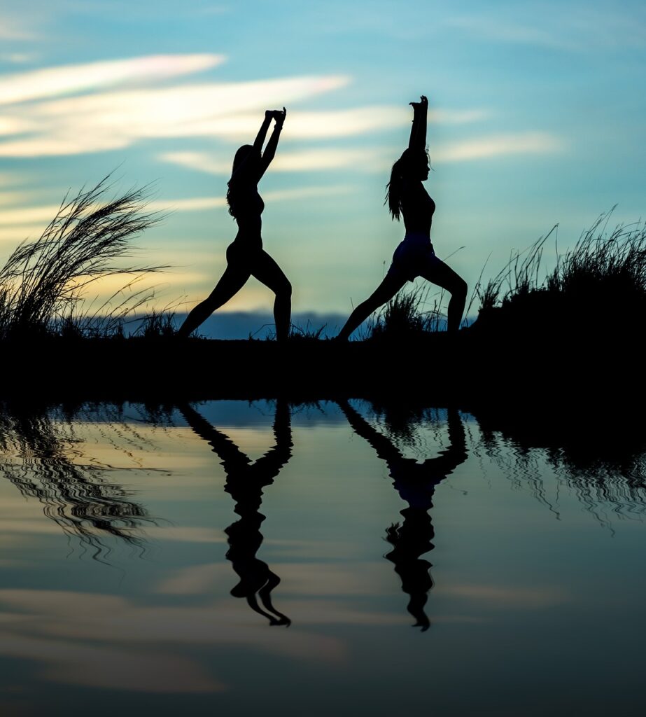 Two people in yoga pose.