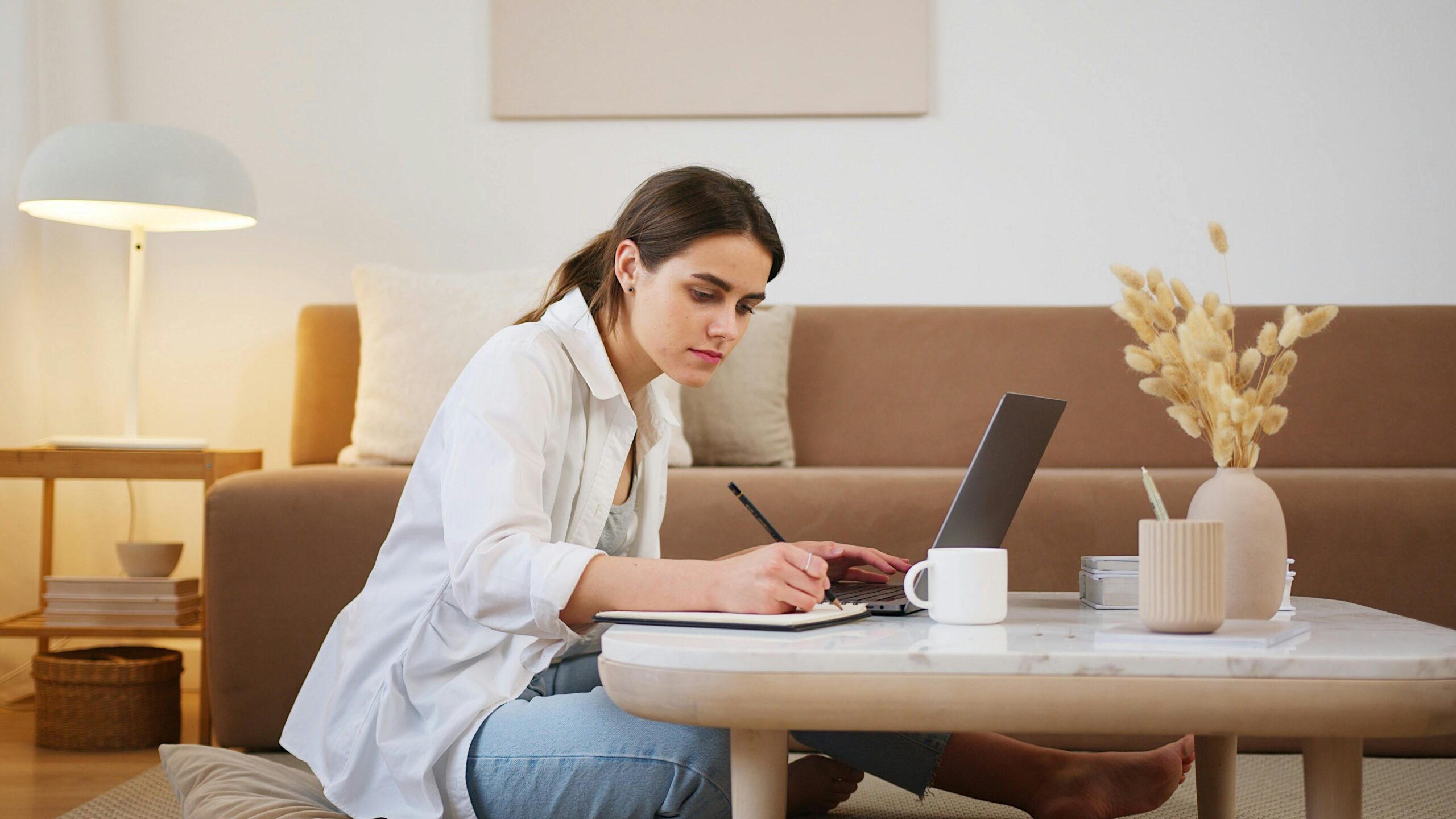 Person focusing while writing notes.